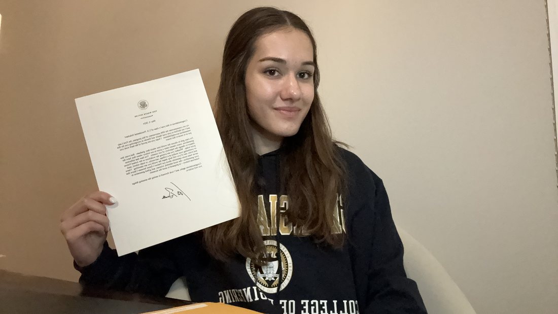Avigail holding an award letter